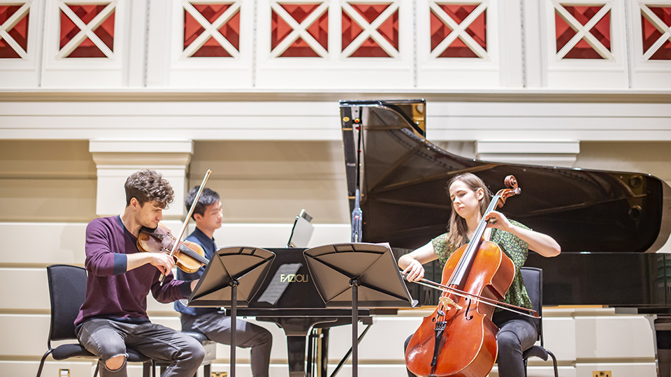 Three RCM students playing together in the RCM's Performance Hall